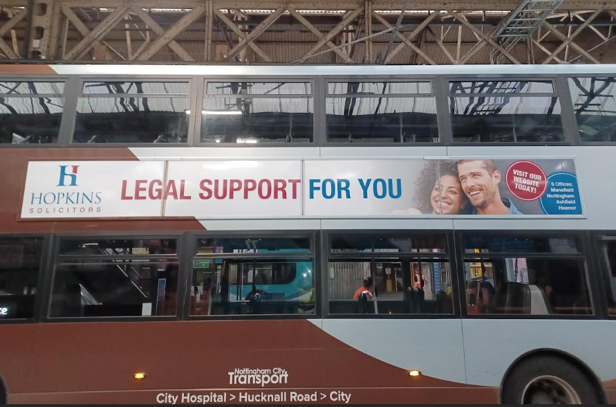 Hopkins Solicitors advert on the side of a double decker bus